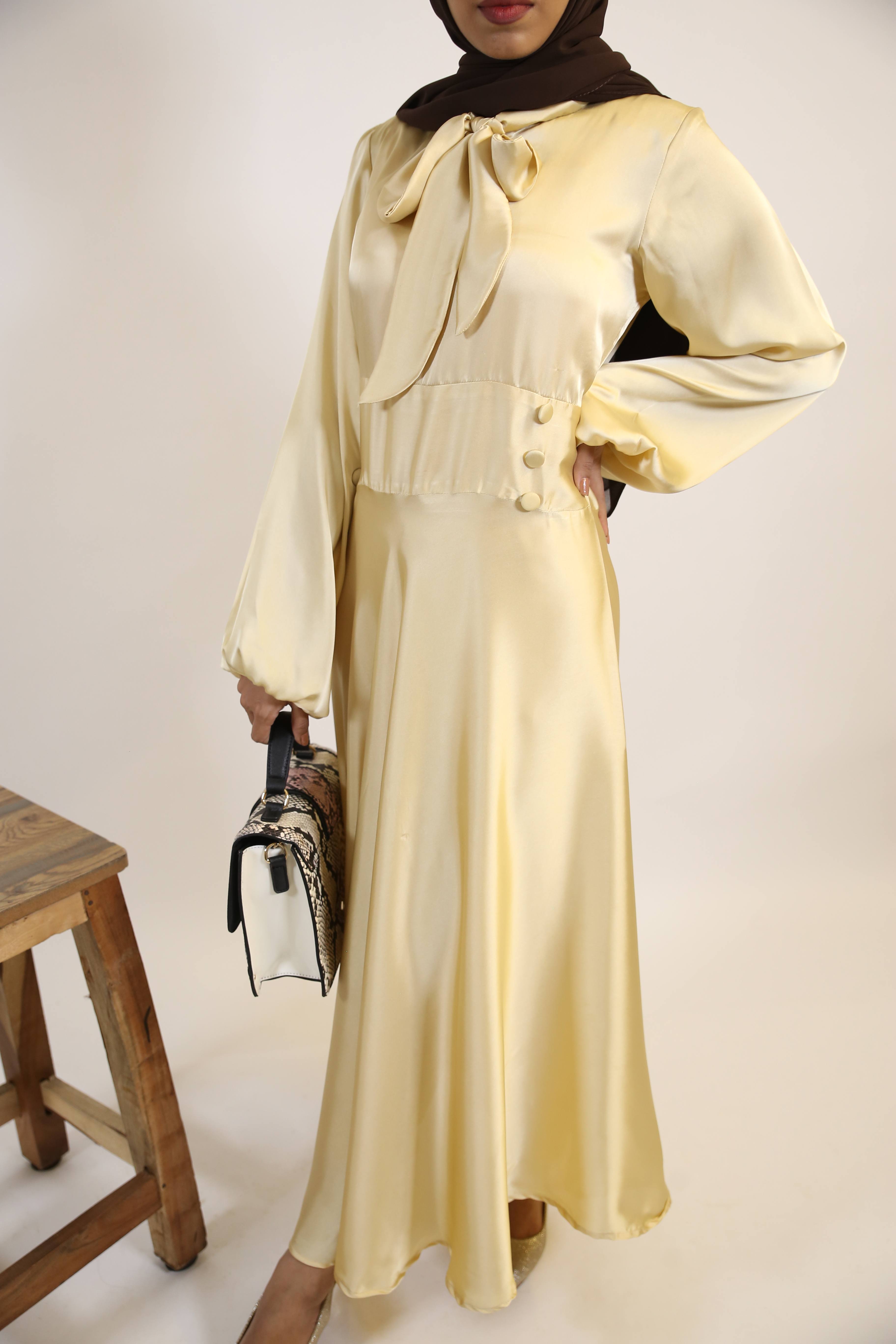 Aqeeq- Glamorous Satin Maxi dress with bow neck and waist button detailing- Pastel Yellow